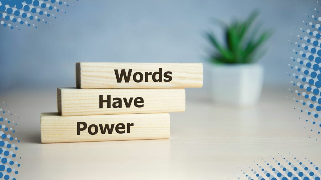 WORDS HAVE POWER, TYPED IN THE ENGLISH LANGUAGE, ON THE FRONT OF 3 BLOCKS STACKED ON A TABLE WITH A PLANT IN THE BACK.